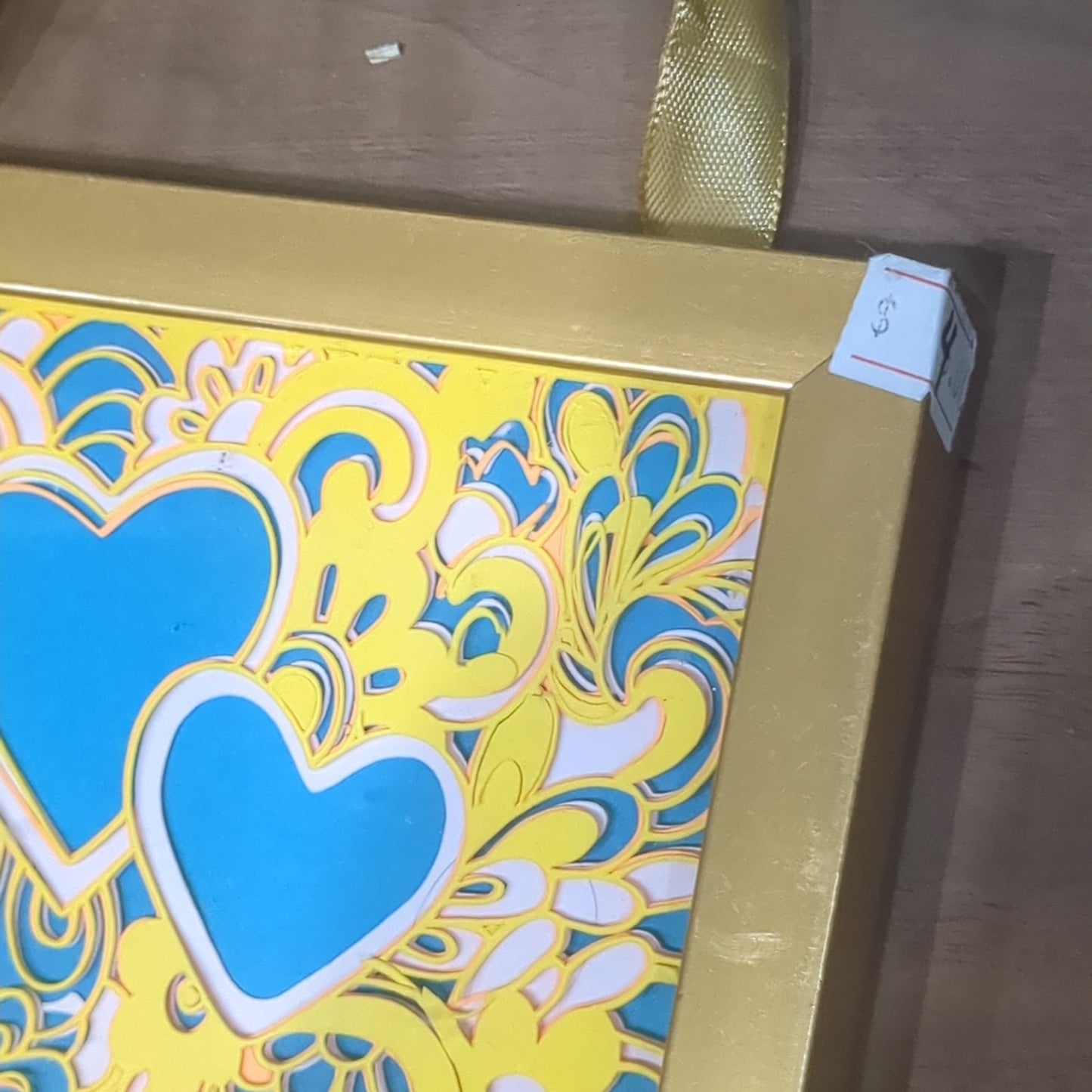 Roughly 5 x 6” gold shadowbox with paper cut Paisley heart