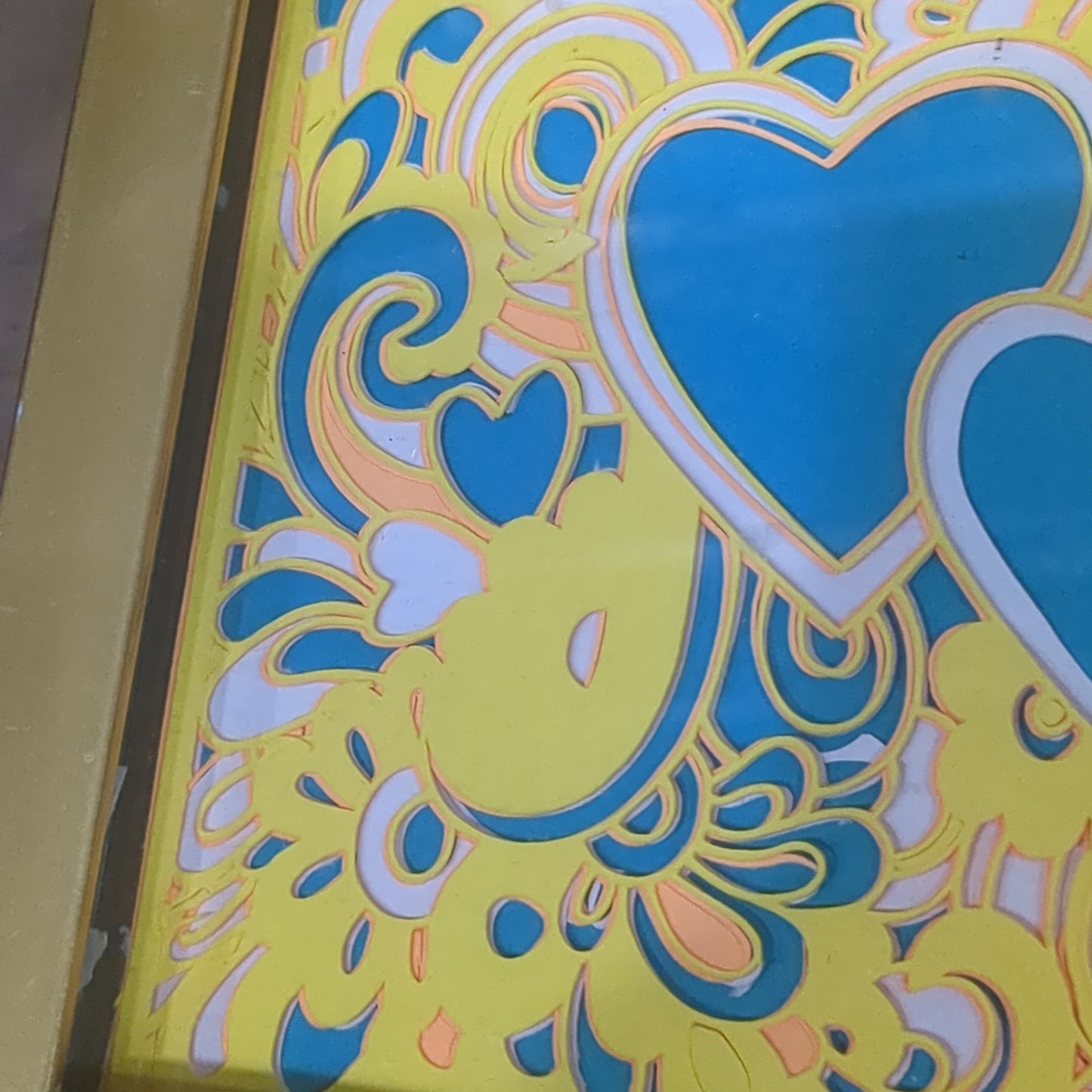 Roughly 5 x 6” gold shadowbox with paper cut Paisley heart