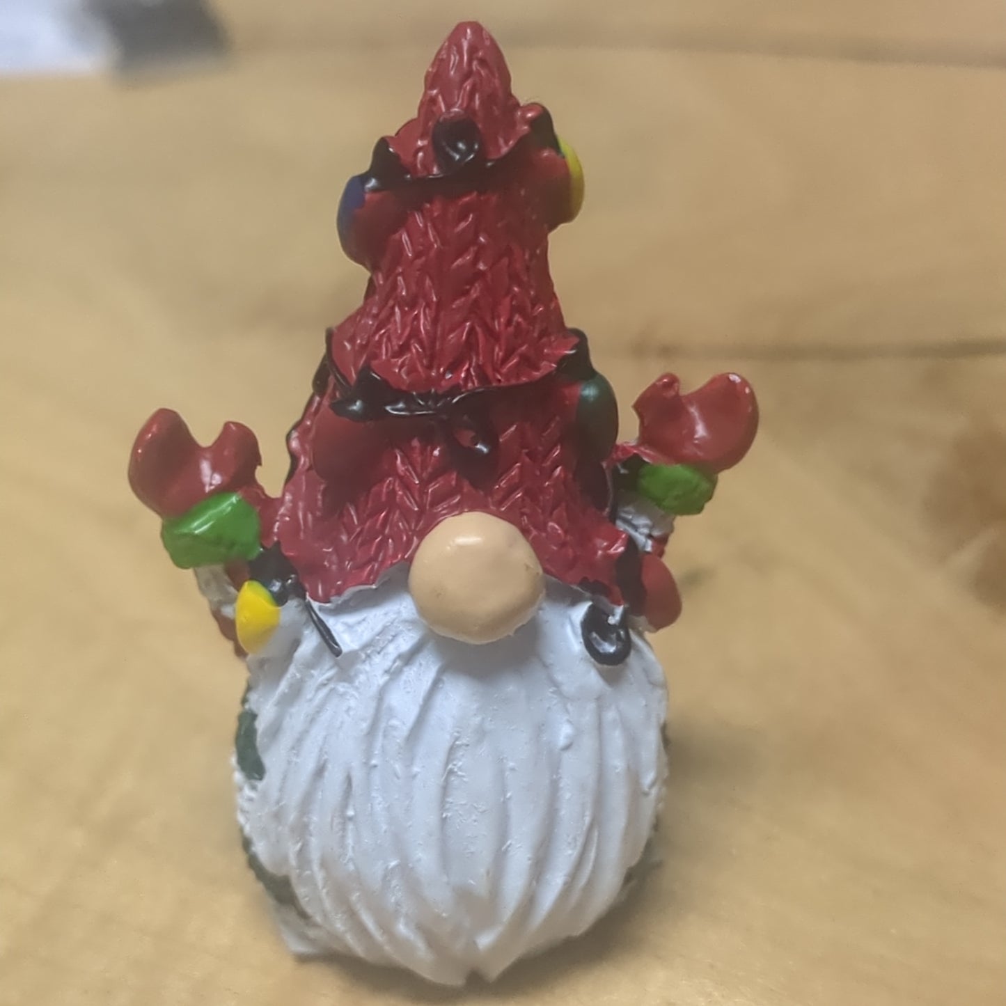 Gnome pocket charm with red hat.