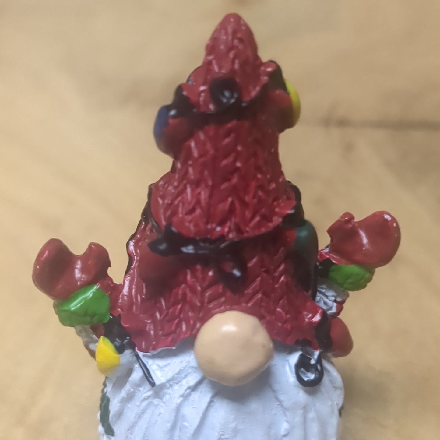 Gnome pocket charm with red hat.