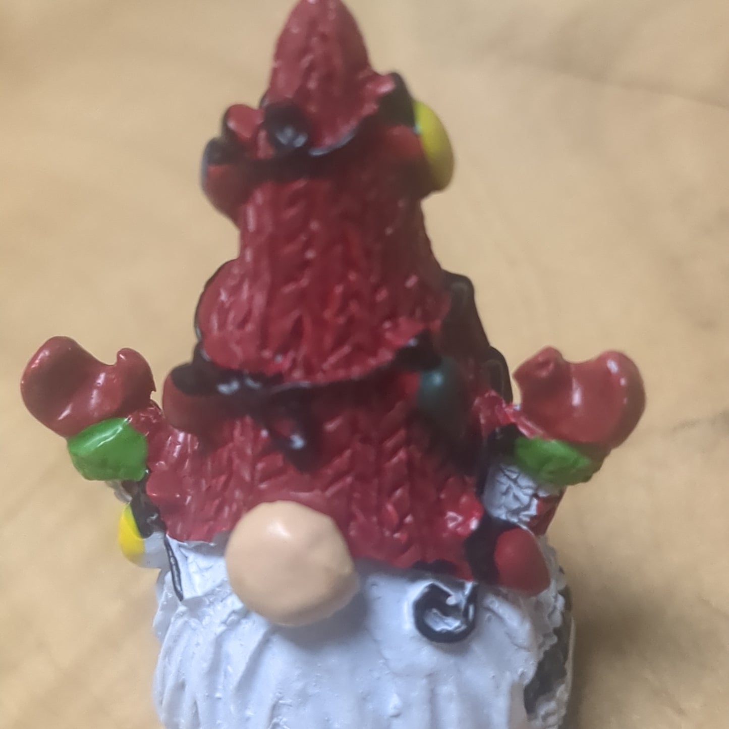 Gnome pocket charm with red hat.