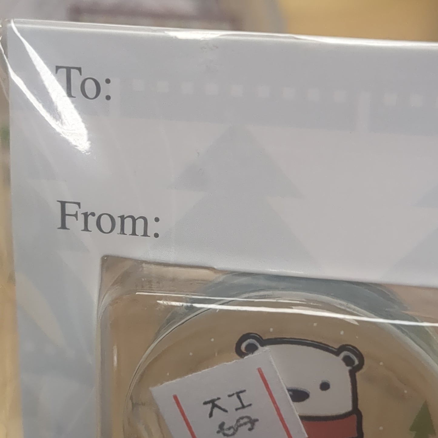 Pocket charm snow globe appearance with polar bear inside. Christmas warms the heart