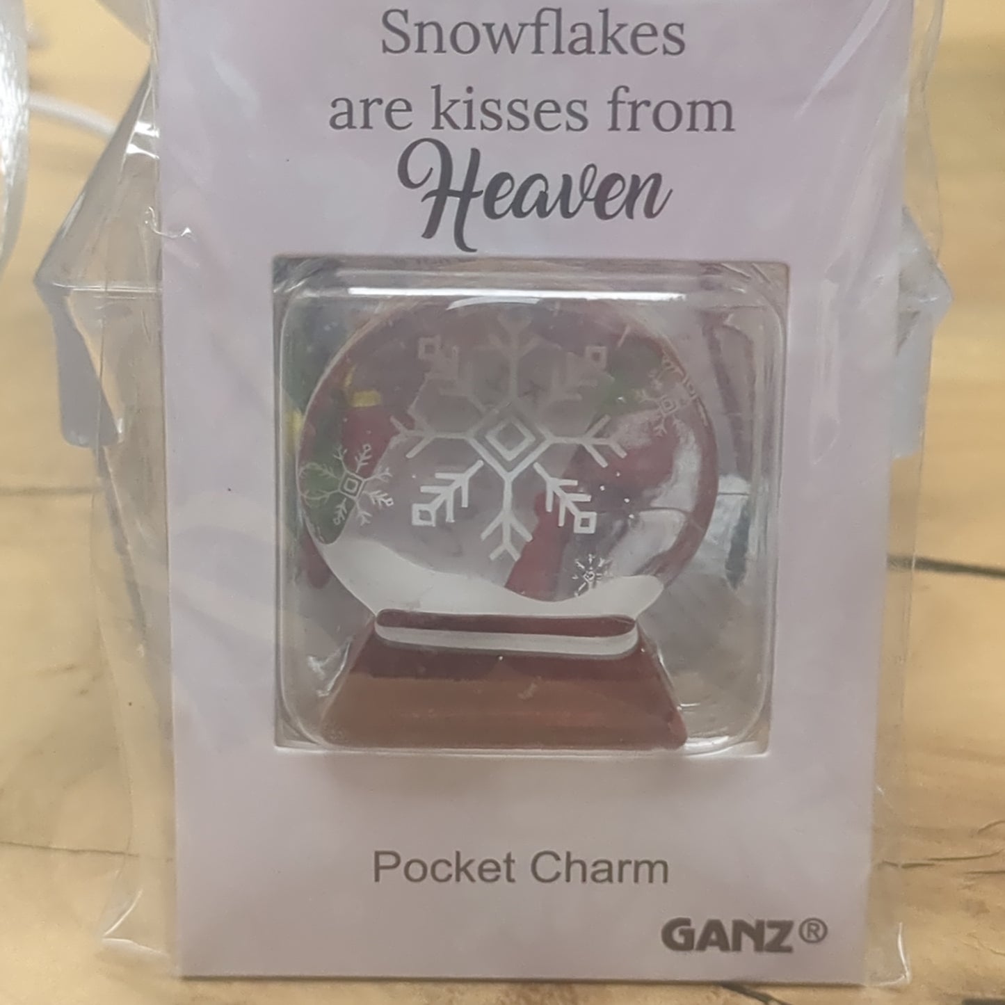 Pocket charm snow globe appearance with snowflake inside. Snowflakes are kisses from heaven
