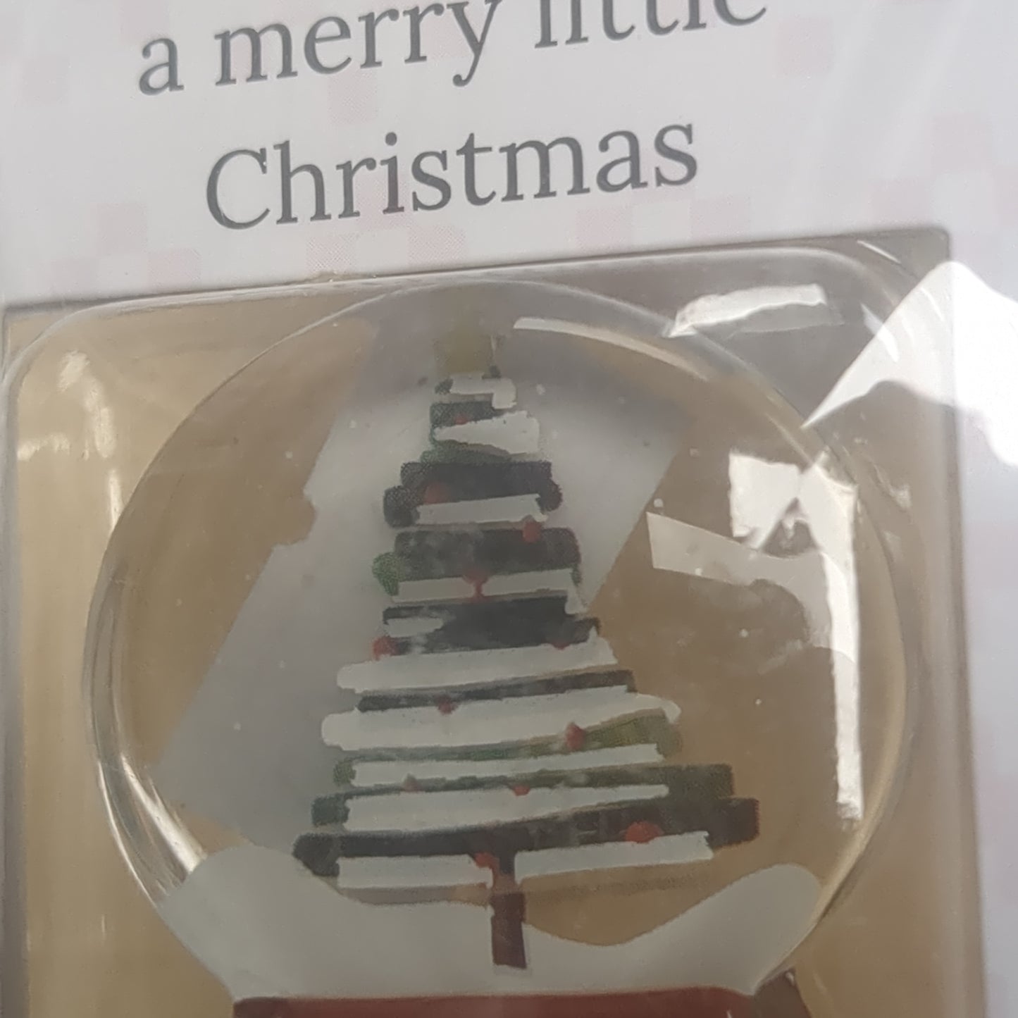 Pocket charm snow globe appearance with tree inside. Have yourself a Merry Little Christmas