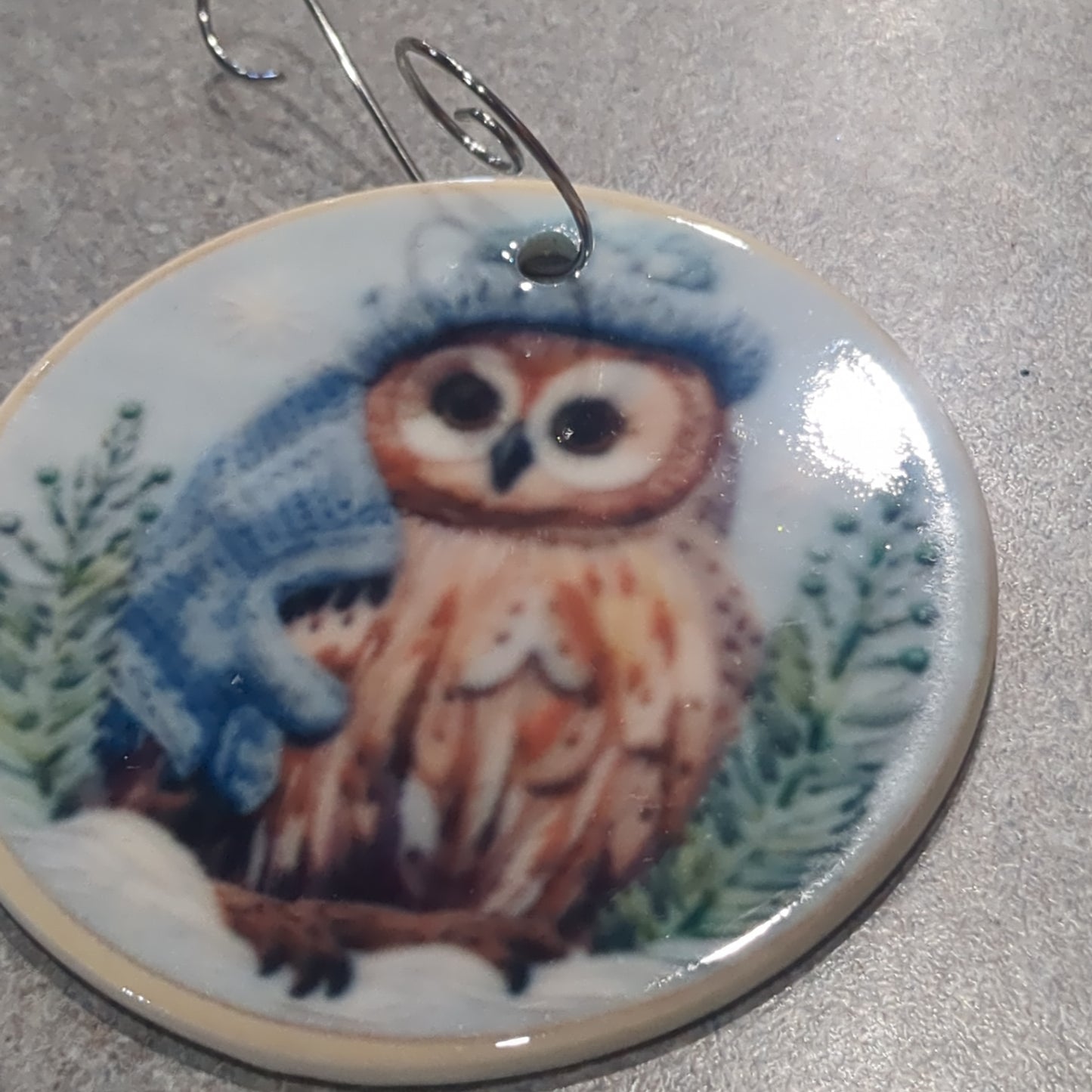 Ceramic ornament owl with a blue hat and a blue scarf, it appears 3D but it is not
