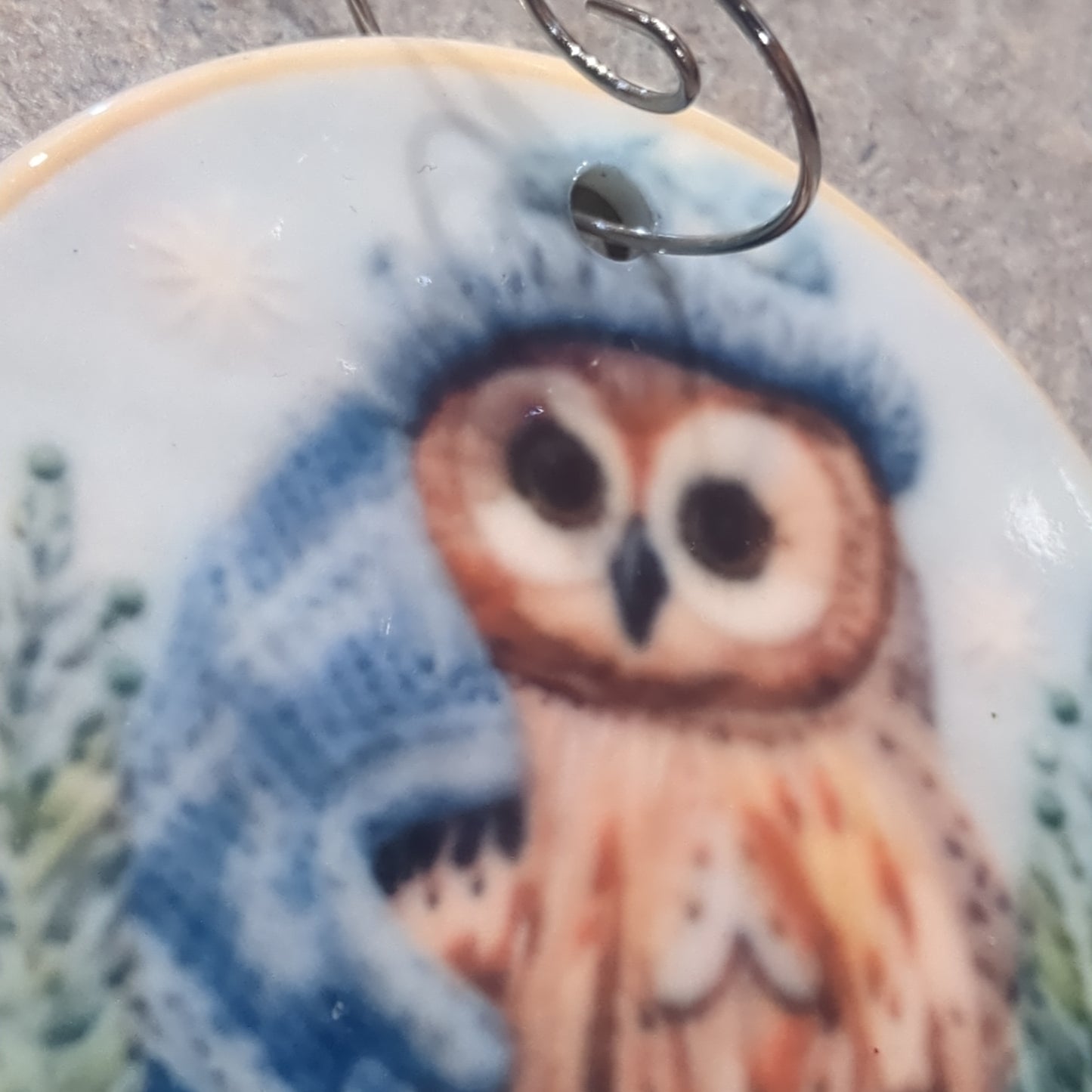 Ceramic ornament owl with a blue hat and a blue scarf, it appears 3D but it is not