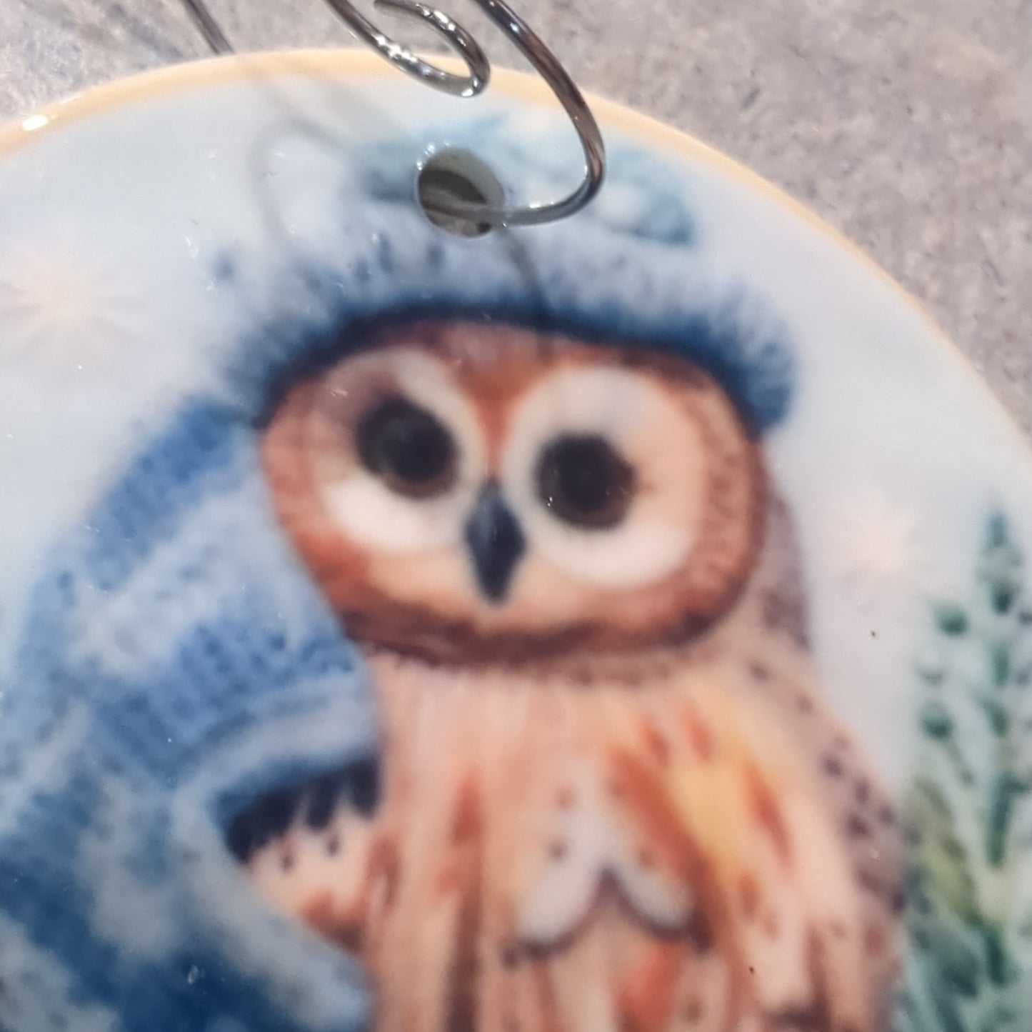 Ceramic ornament owl with a blue hat and a blue scarf, it appears 3D but it is not