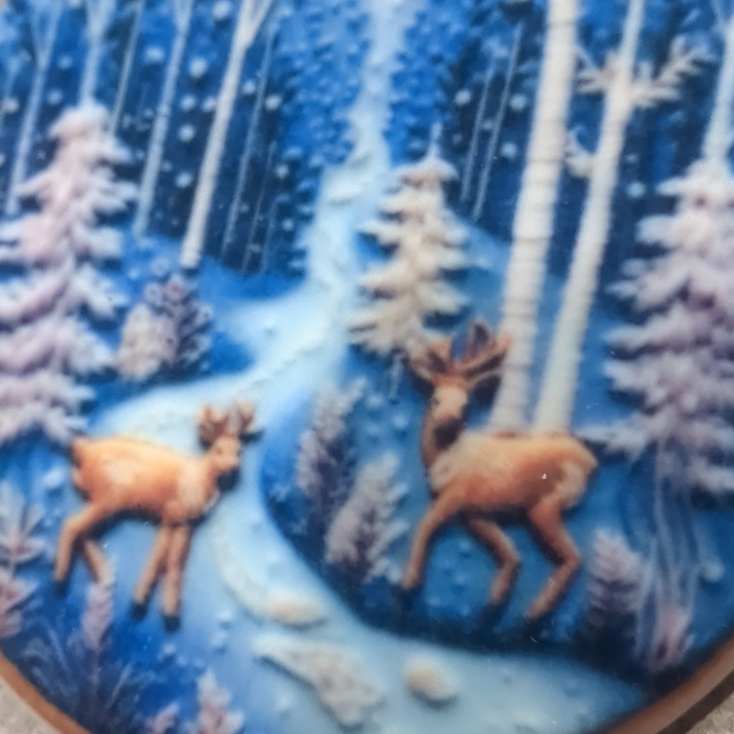 Ceramic ornament with a pair of deer by a river in the forest, it appears 3D but it is not