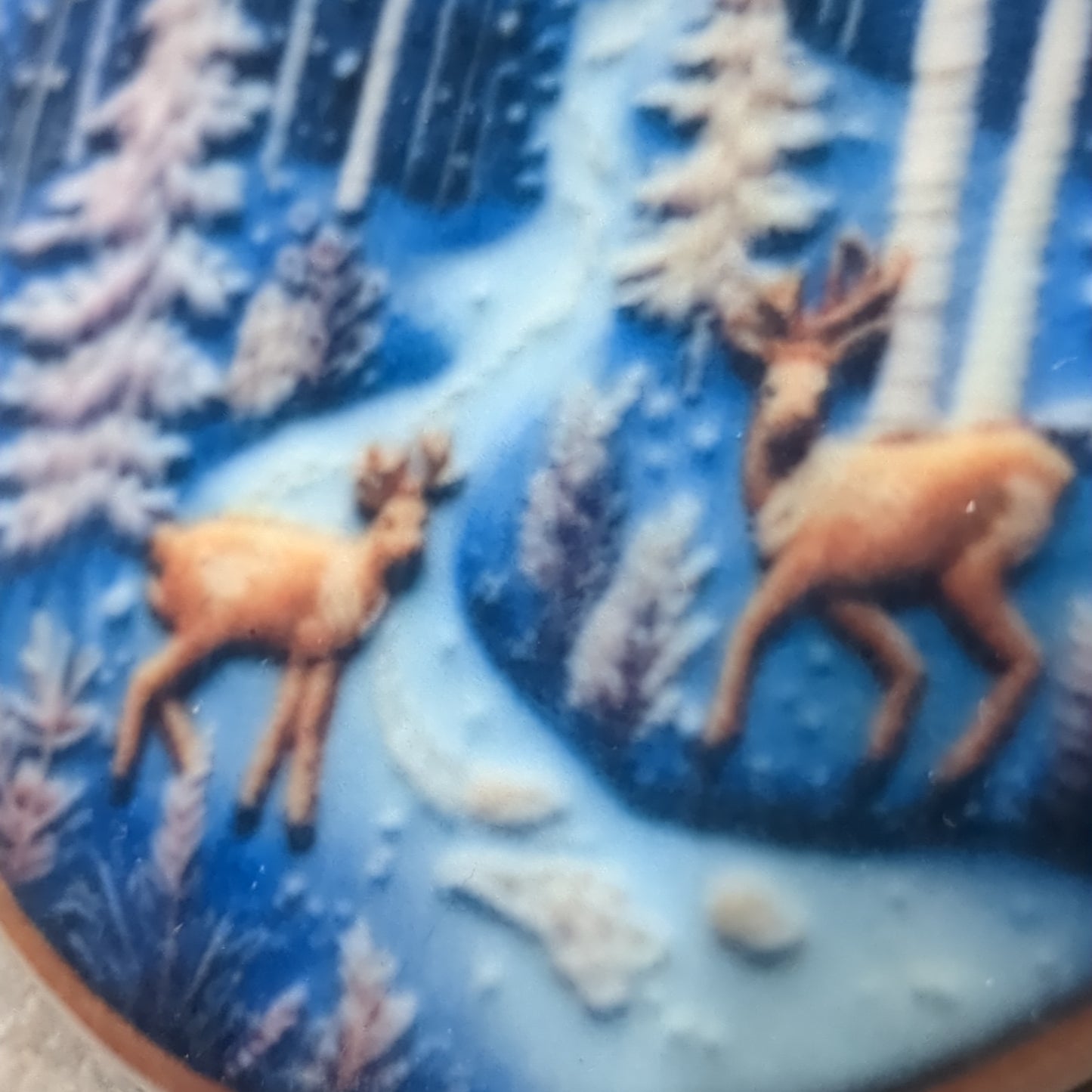 Ceramic ornament with a pair of deer by a river in the forest, it appears 3D but it is not