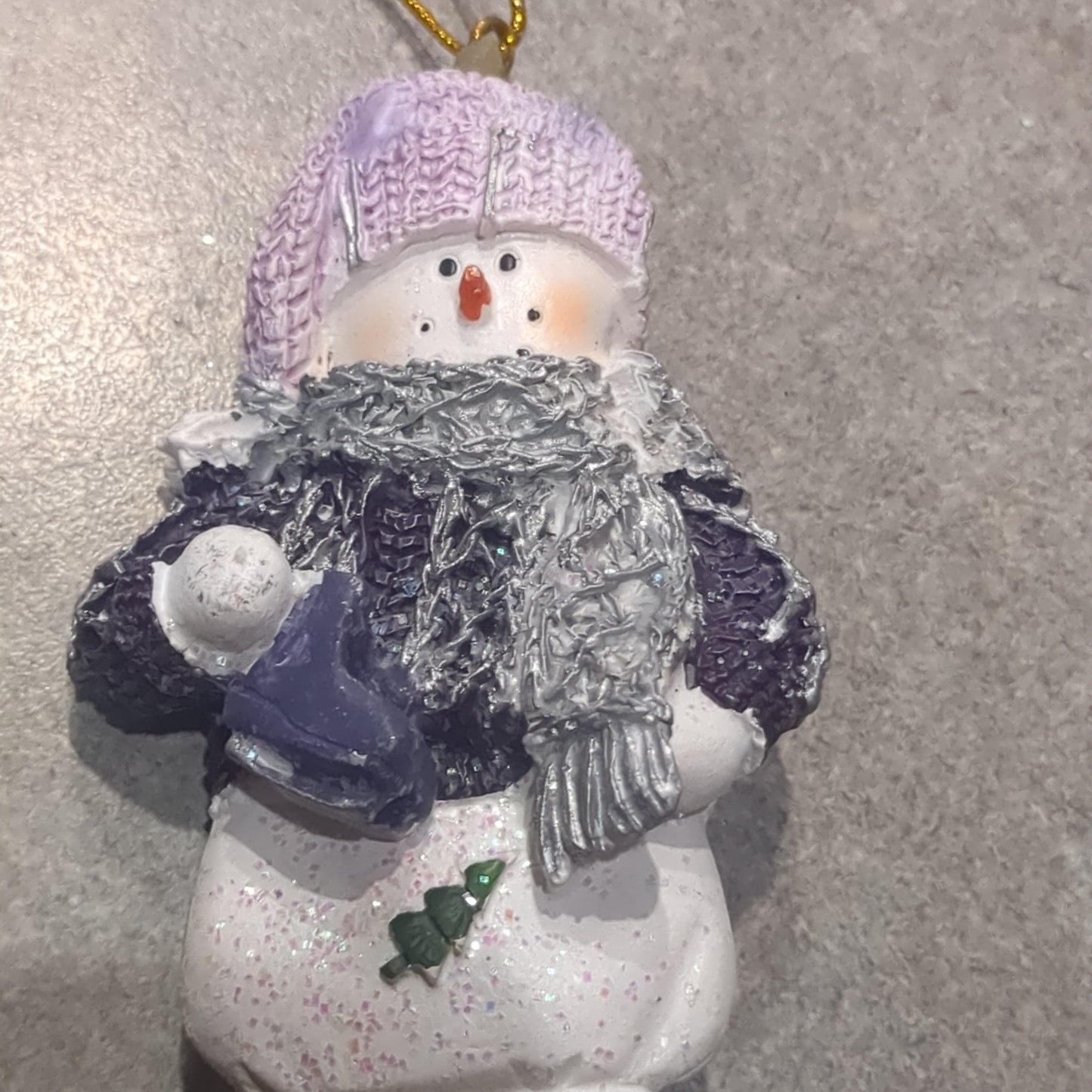 Op2 Polycrylic snowman ornament with an ice skate lilac and purple
