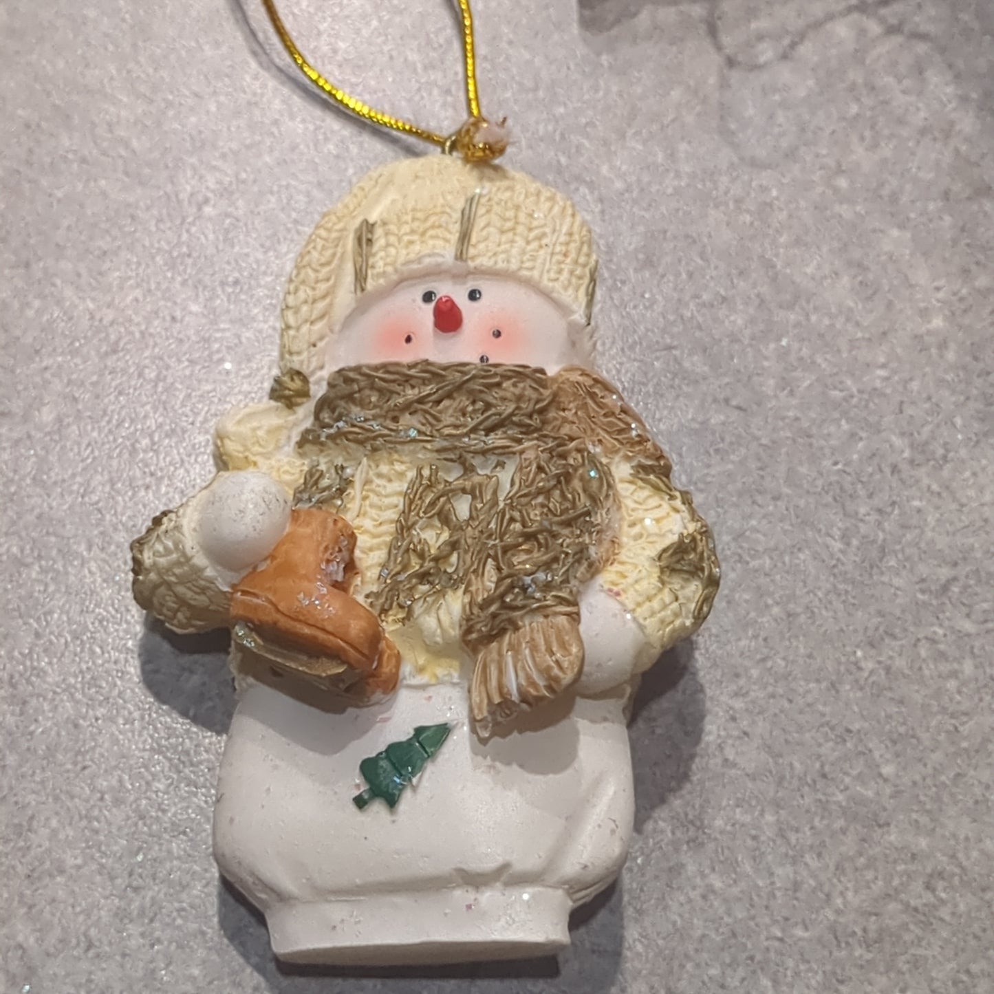 Oy5 Polycrylic snowman ornament with an ice skate yellow