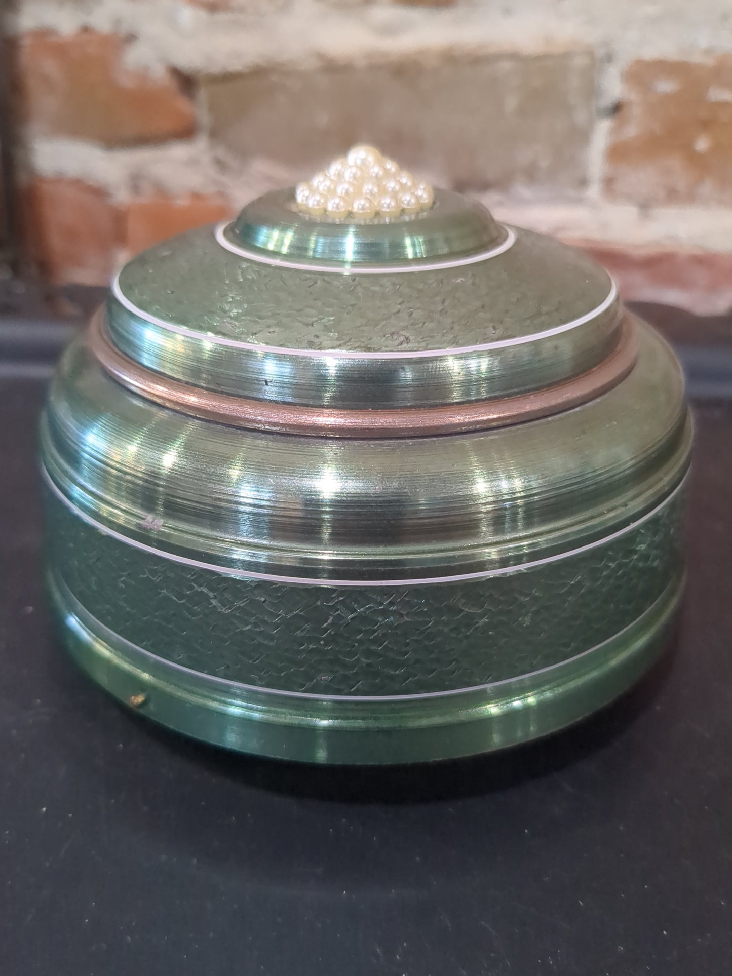Vintage, round, aluminum, powder puff music box with faux pearls on top. Mb1