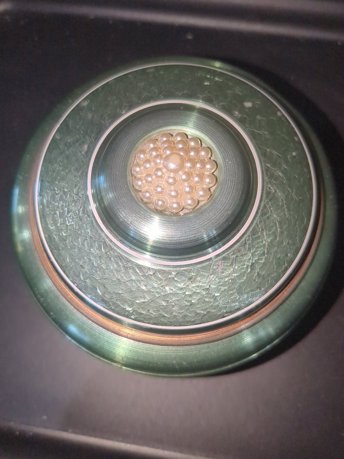 Vintage, round, aluminum, powder puff music box with faux pearls on top. Mb1