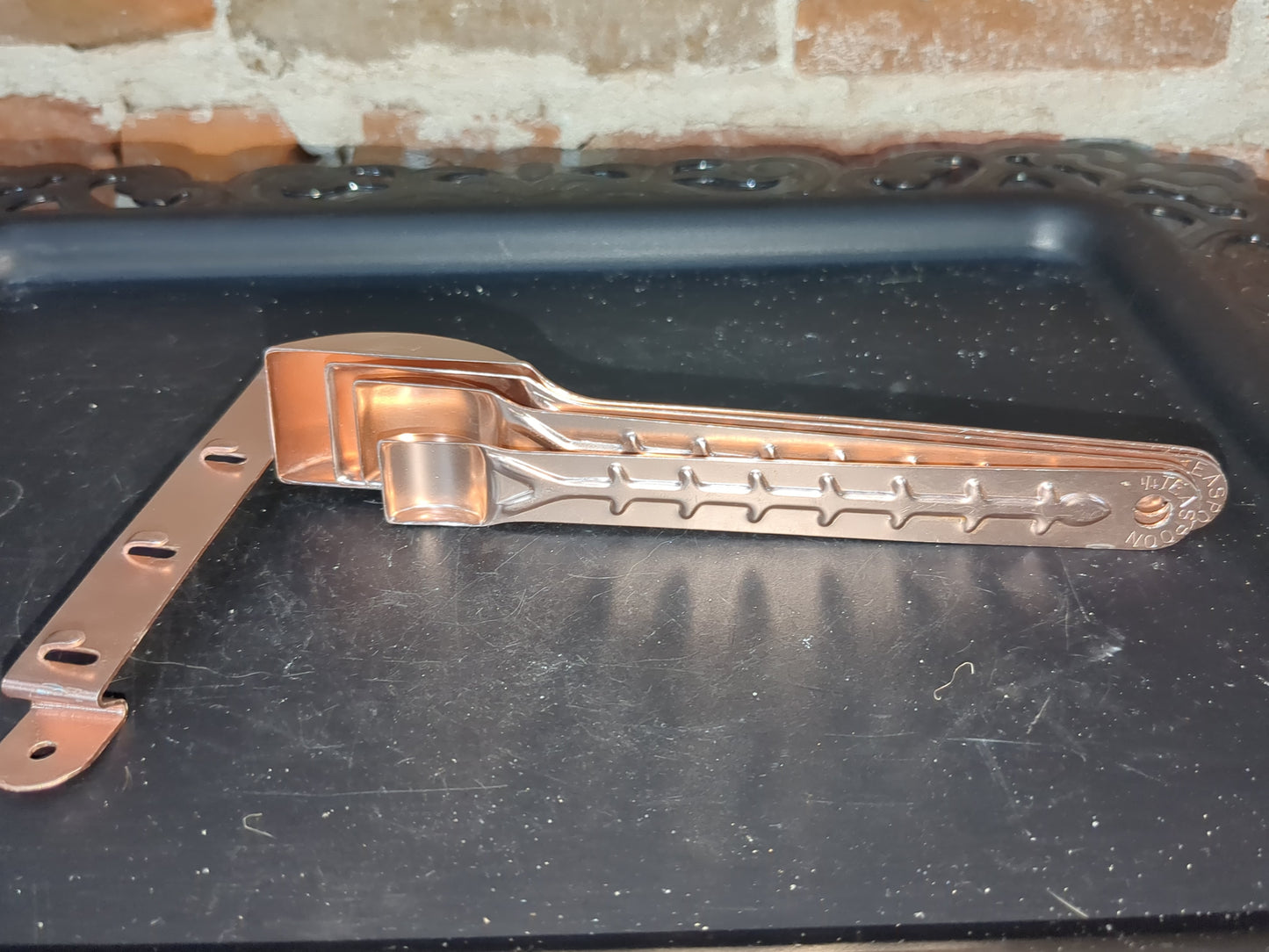 Vintage aluminum pink or copper colored measuring spoons with hanging rail alu253