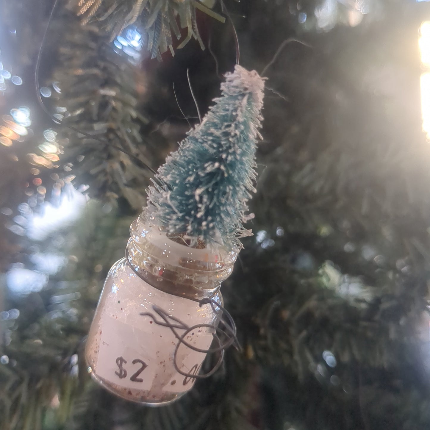 Glass jar With Tree Ornament.  Jar is 1 inch tall