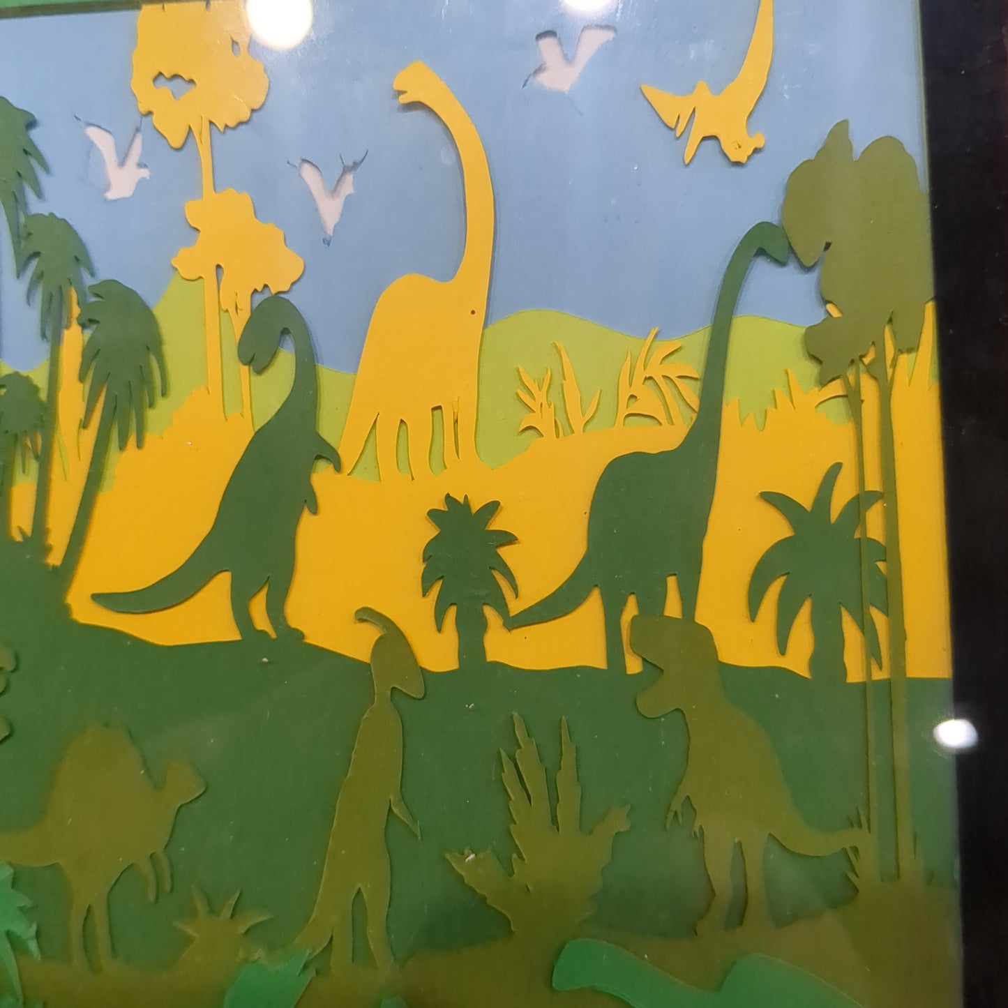 8 x 10” frame with 5 x 7" paper cut dinosaur scene