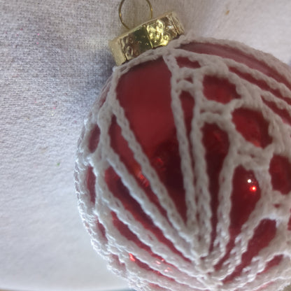 Red glass ornament with crochet