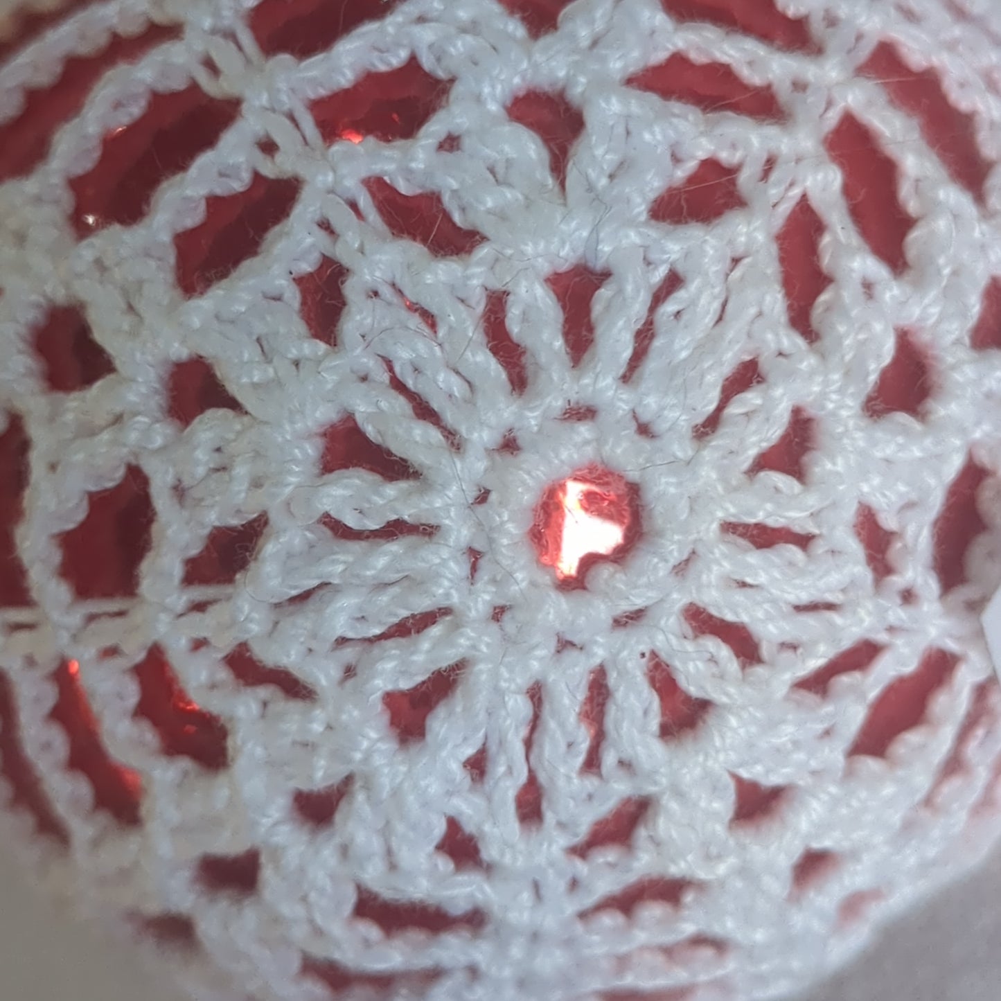 Red glass ornament with crochet