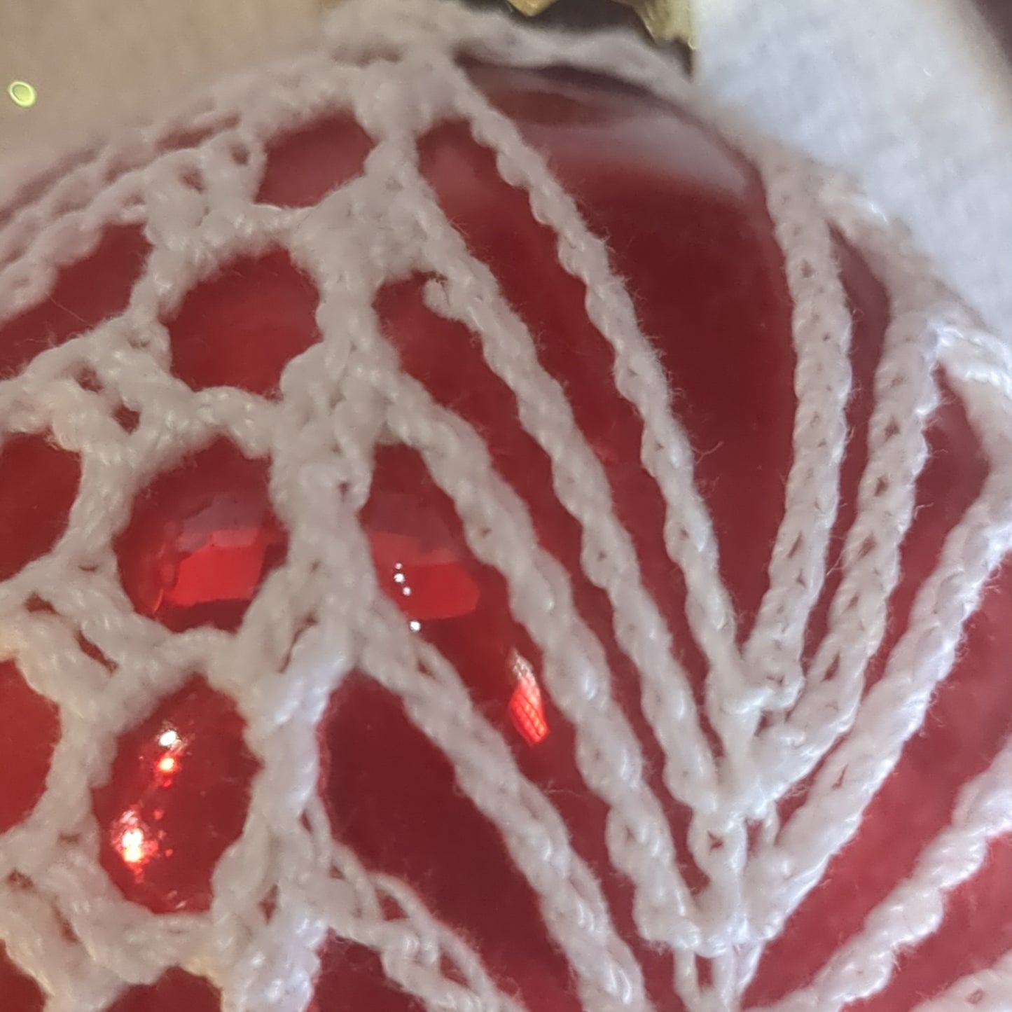 Red glass ornament with crochet