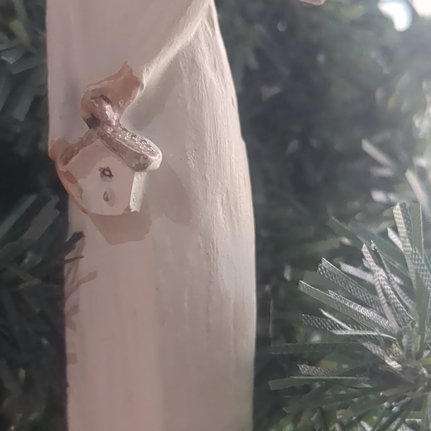 Angel holding a birdhouse ornament