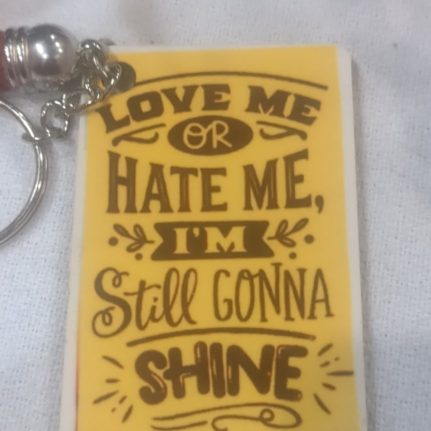 Keychain love me or hate me I'm still gonna shine