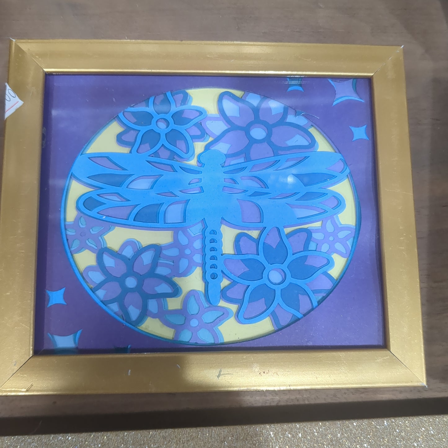 Roughly 5 by 6 inch gold shadow box with paper cut dragonfly