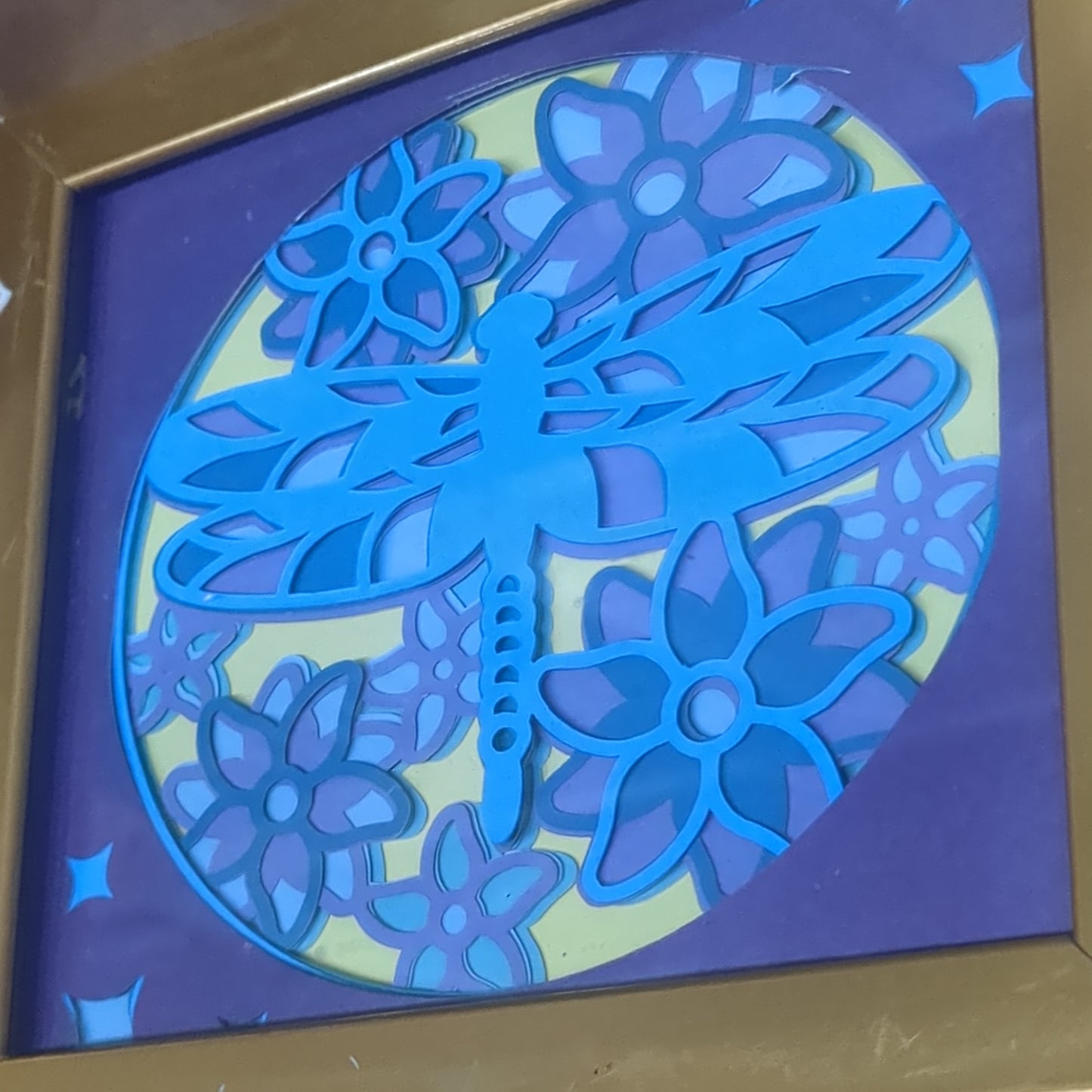 Roughly 5 by 6 inch gold shadow box with paper cut dragonfly