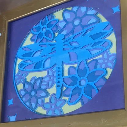 Roughly 5 by 6 inch gold shadow box with paper cut dragonfly