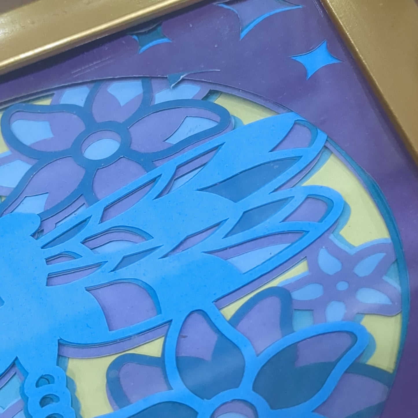 Roughly 5 by 6 inch gold shadow box with paper cut dragonfly