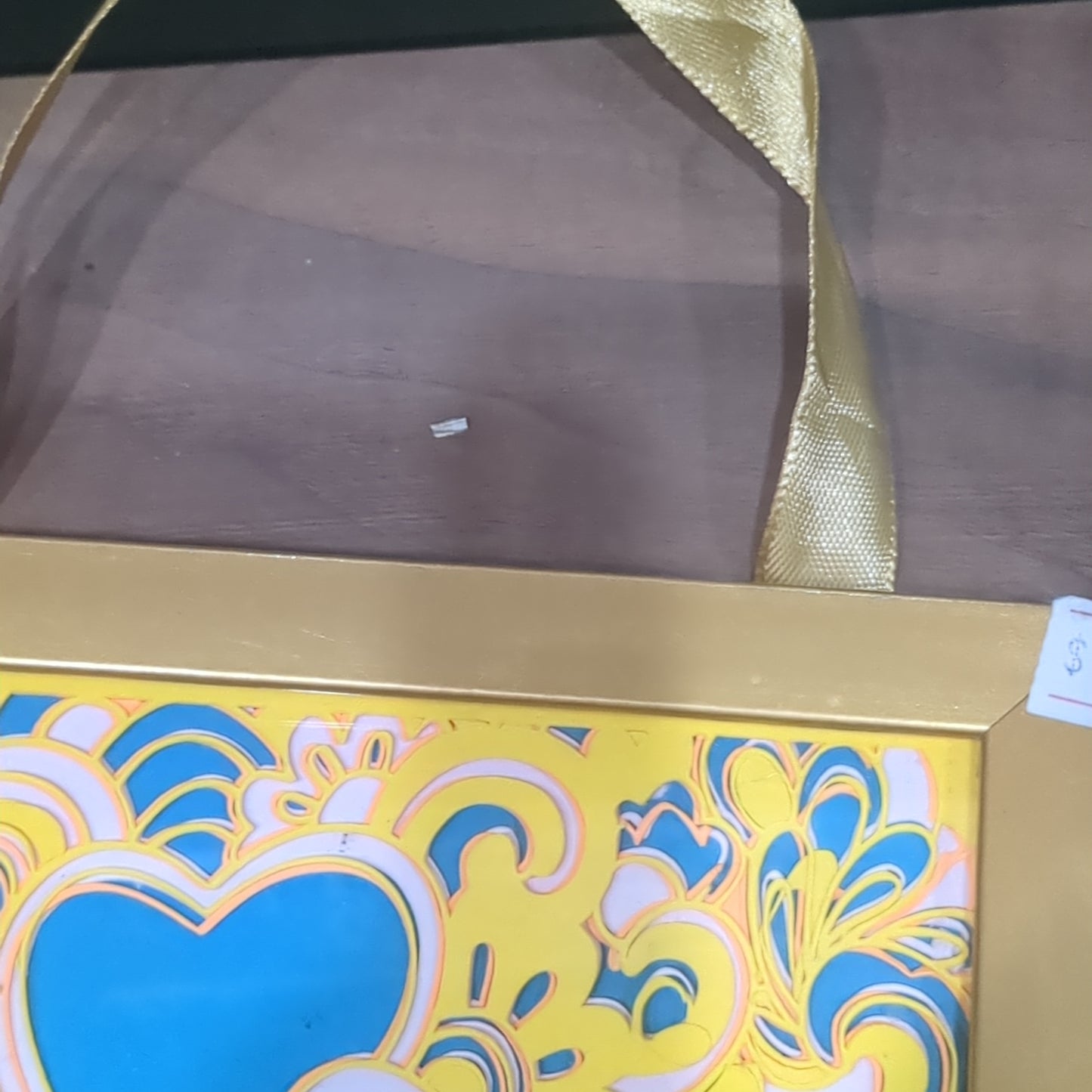 Roughly 5 x 6” gold shadowbox with paper cut Paisley heart