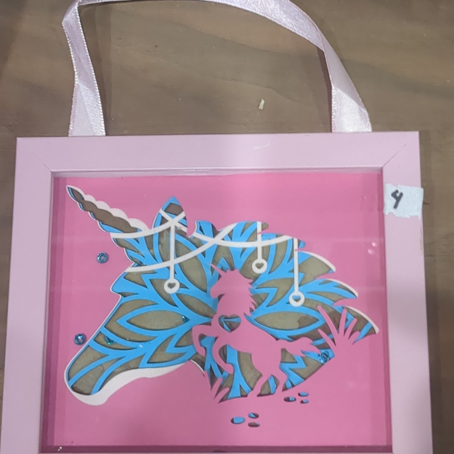 Roughly 5 x 6 inch pink shadow box frame with Papercut unicorn