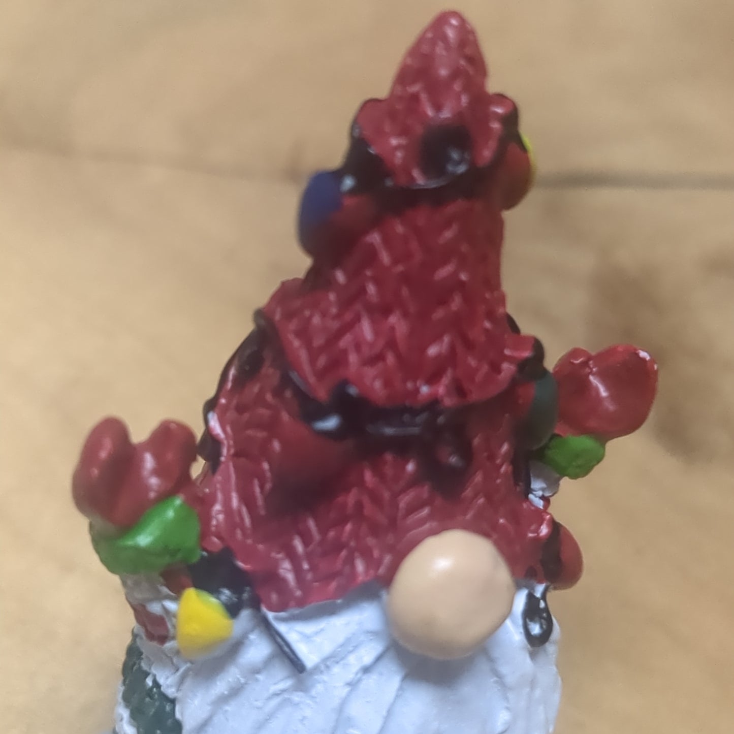 Gnome pocket charm with red hat.