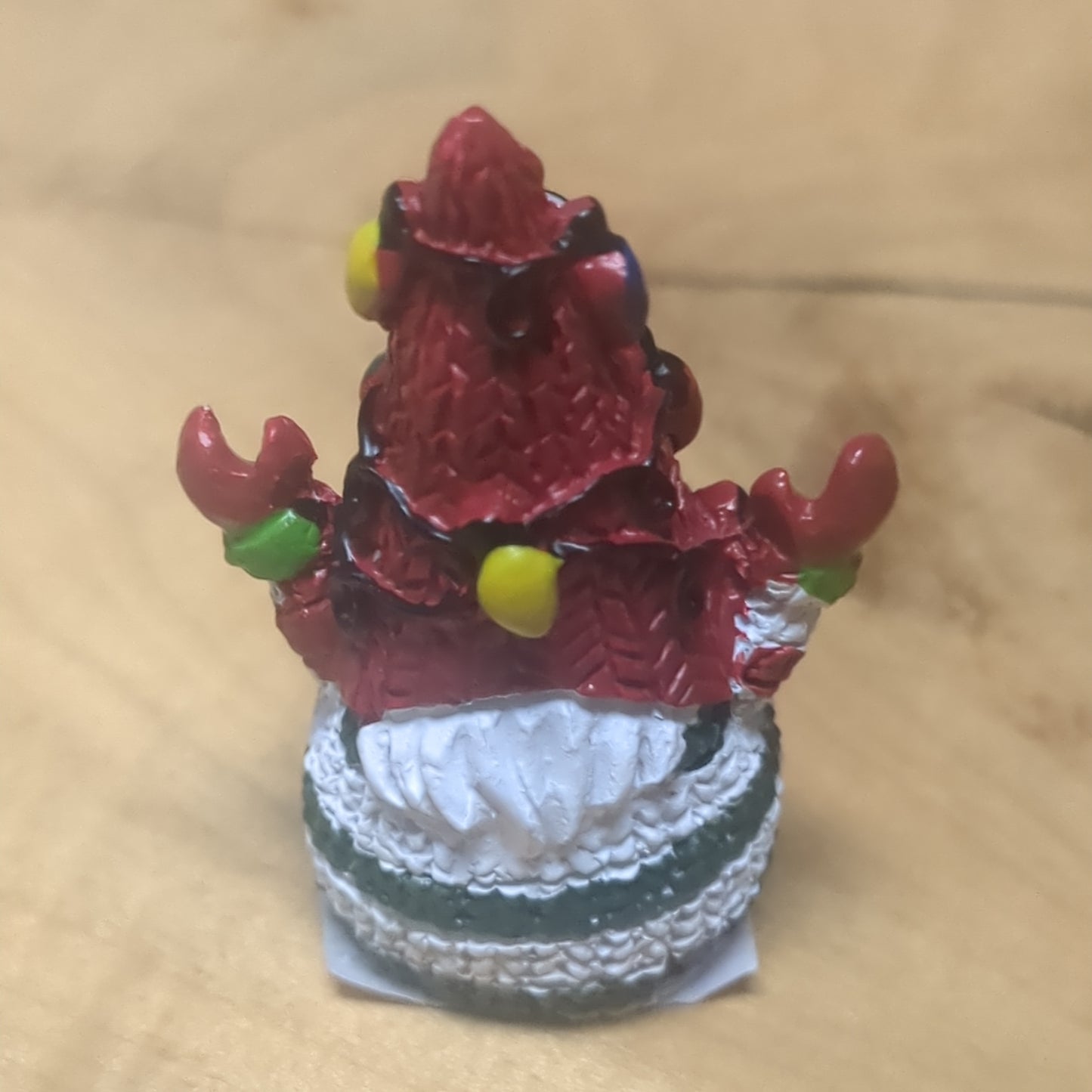 Gnome pocket charm with red hat.
