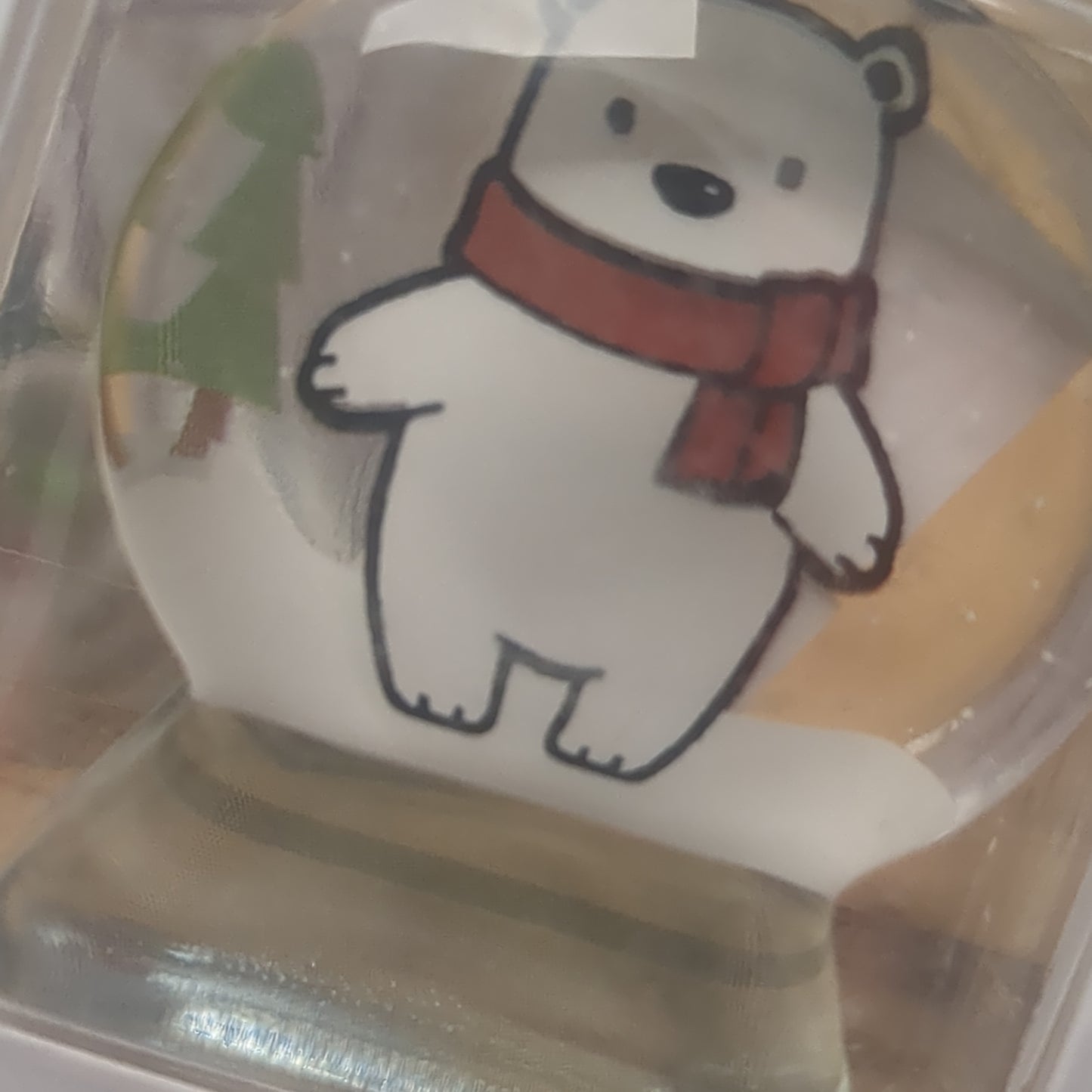 Pocket charm snow globe appearance with polar bear inside. Christmas warms the heart
