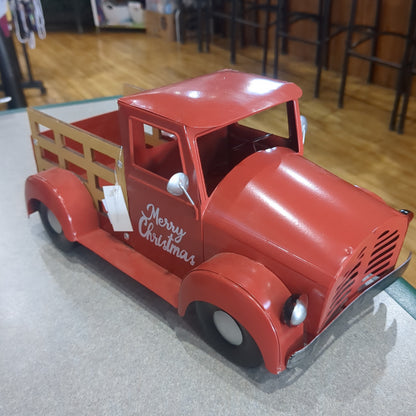 Red metal truck for decor says Merry Christmas