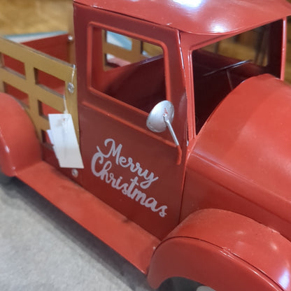 Red metal truck for decor says Merry Christmas
