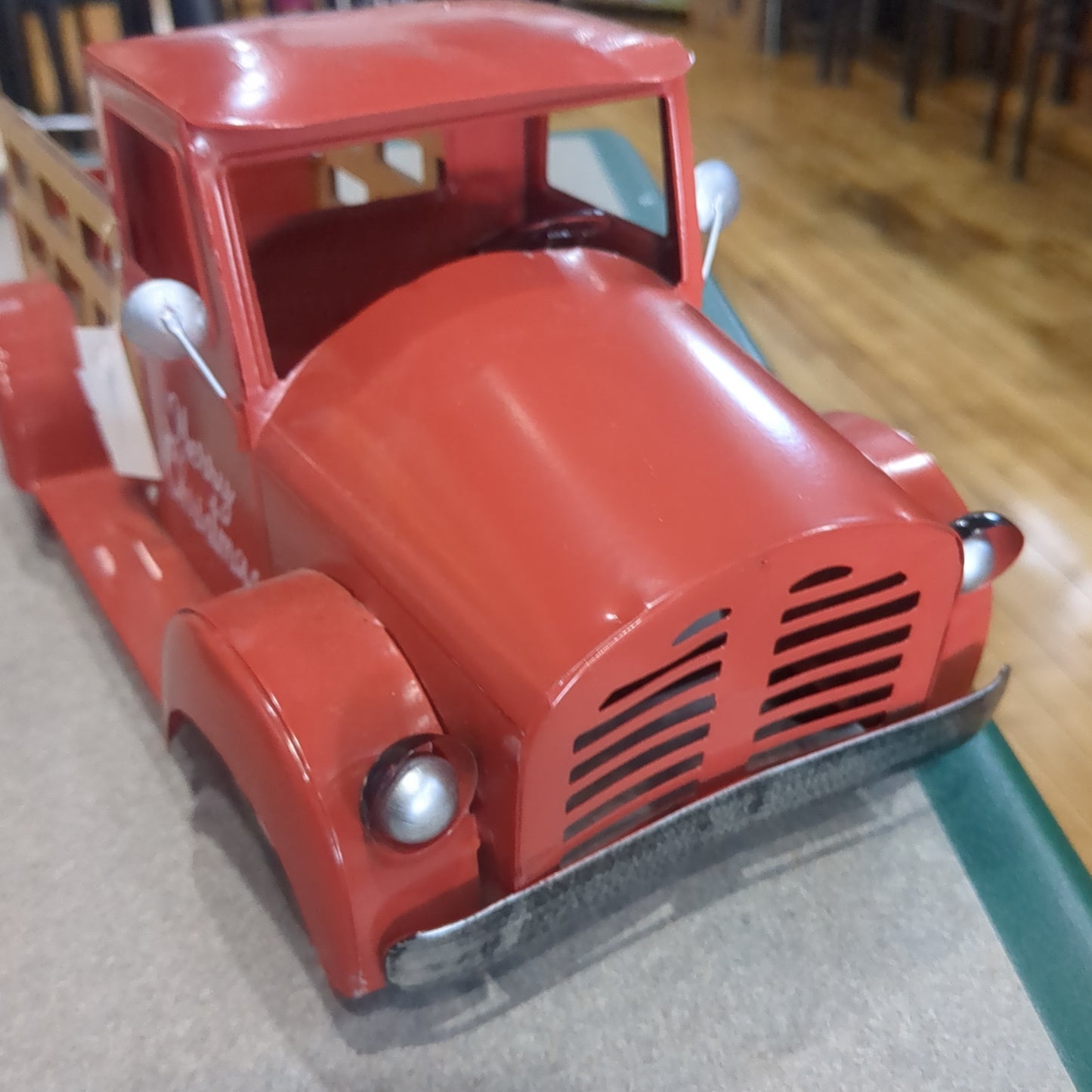 Red metal truck for decor says Merry Christmas