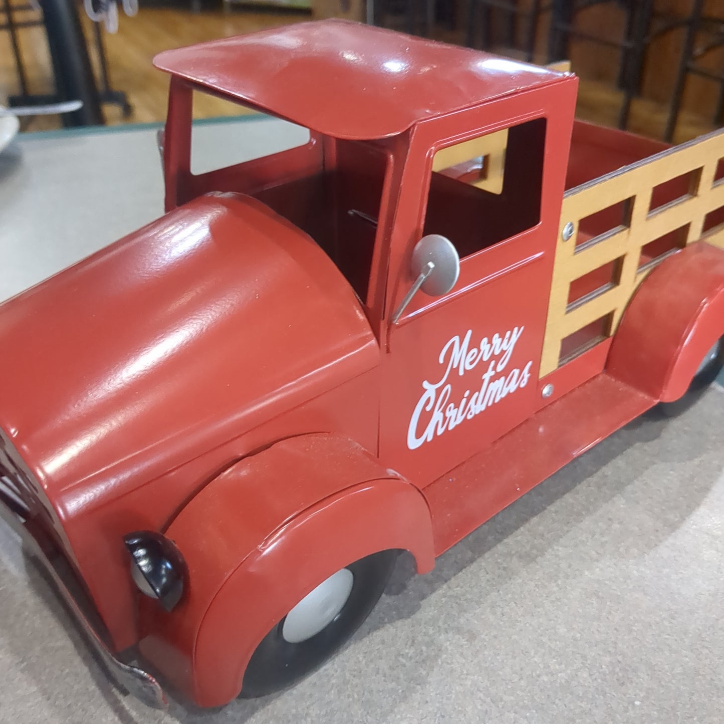 Red metal truck for decor says Merry Christmas