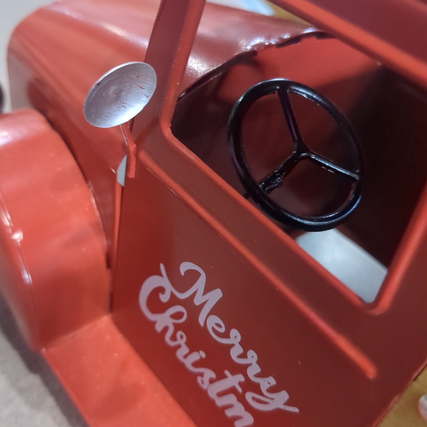 Red metal truck for decor says Merry Christmas