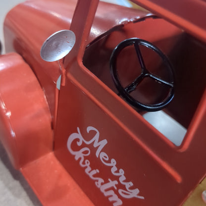 Red metal truck for decor says Merry Christmas