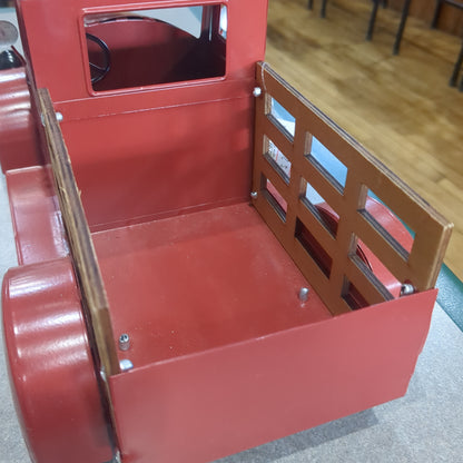 Red metal truck for decor says Merry Christmas