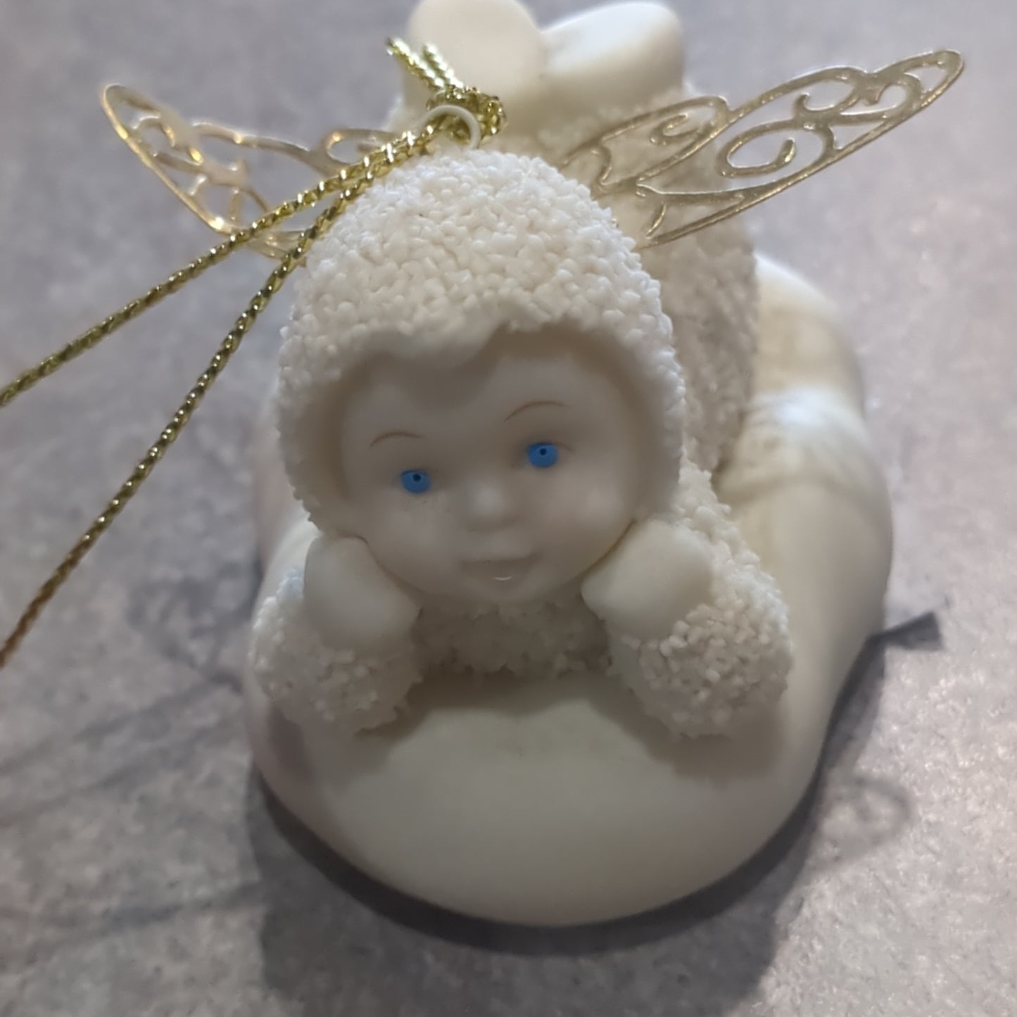 Department 56 snowbabies angel ornament laying down