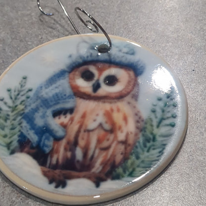 Ceramic ornament owl with a blue hat and a blue scarf, it appears 3D but it is not