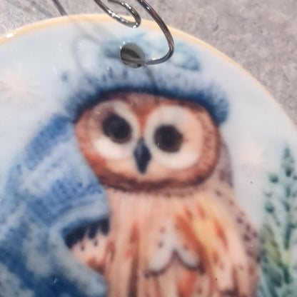 Ceramic ornament owl with a blue hat and a blue scarf, it appears 3D but it is not