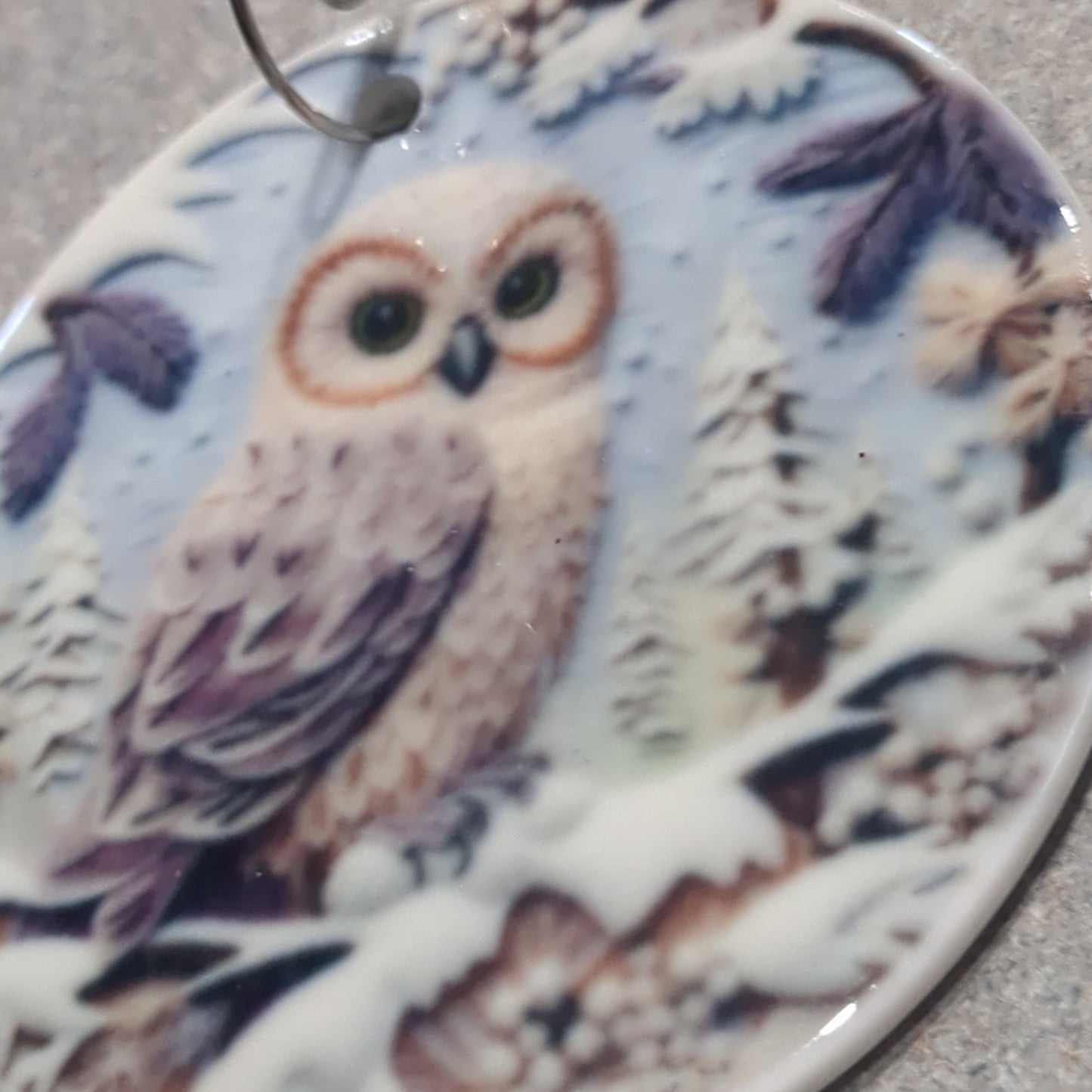 Ceramic ornament with an owl sitting on a branch, it appears 3D but it is not