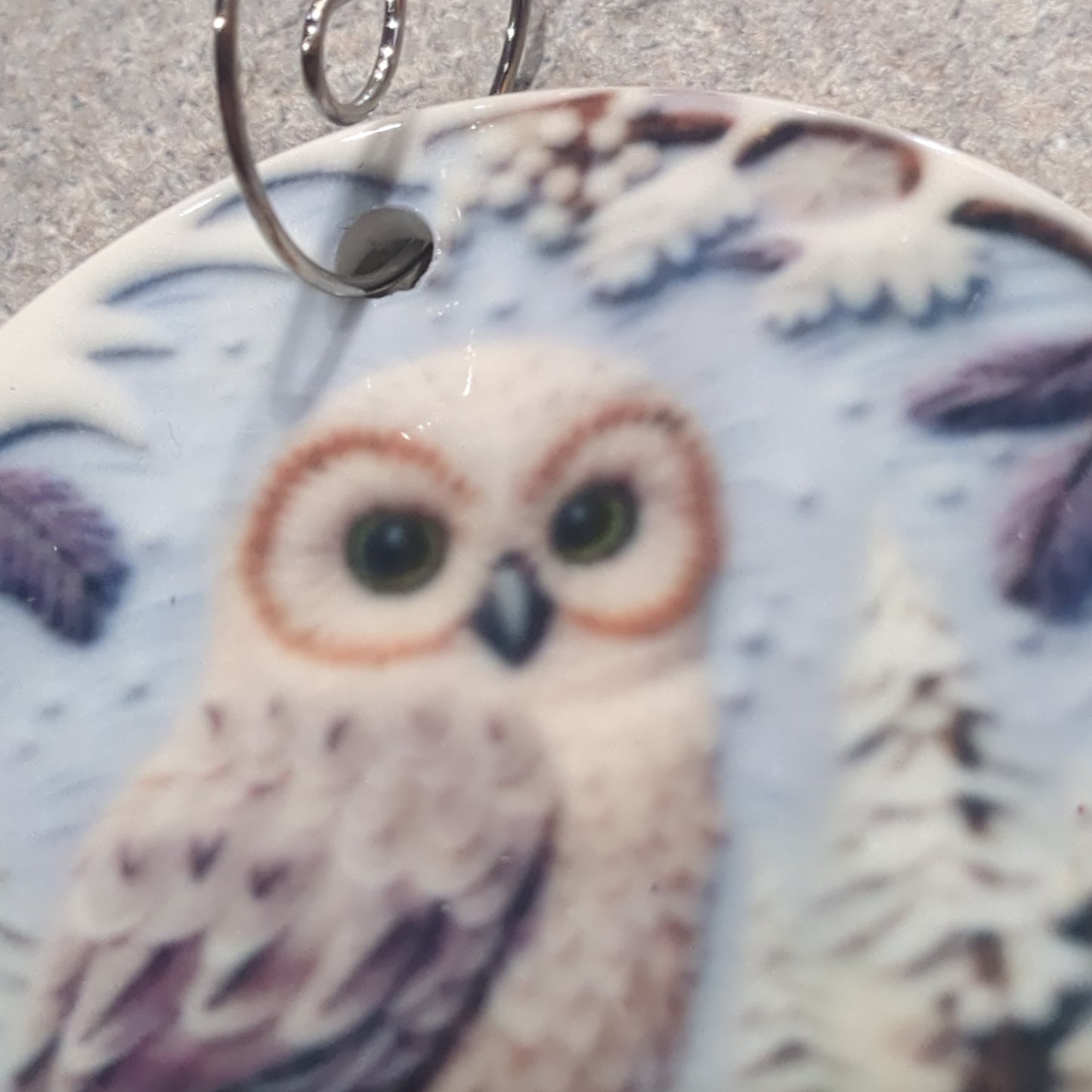 Ceramic ornament with an owl sitting on a branch, it appears 3D but it is not