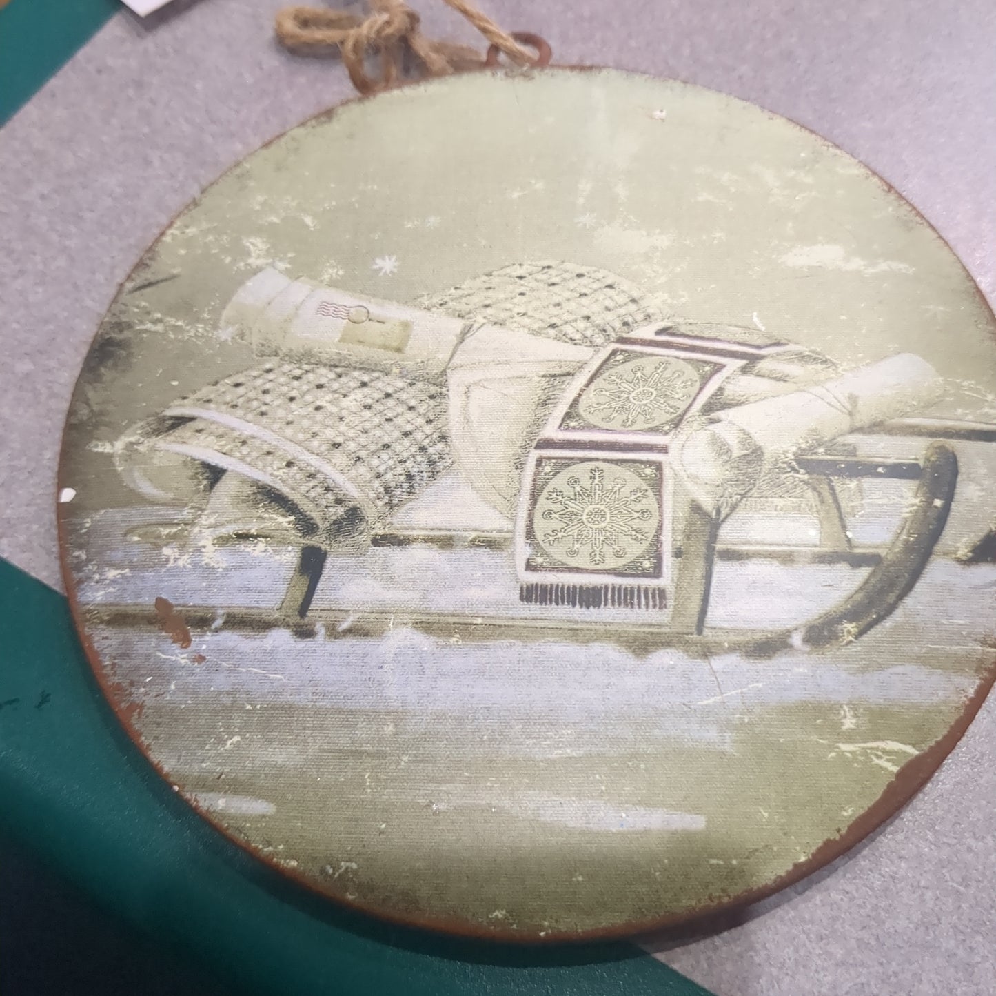 6 inch tin ornament with a sled