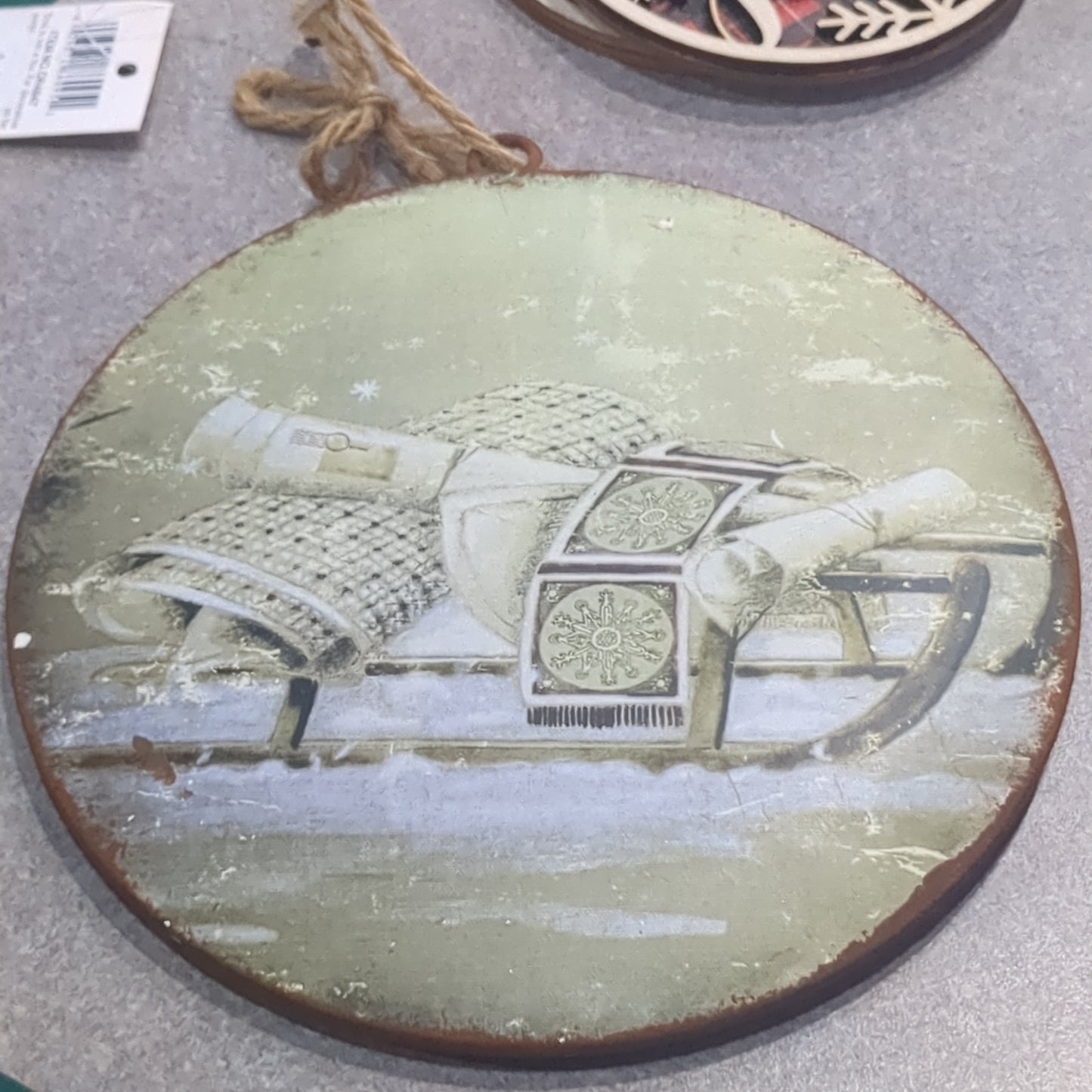 6 inch tin ornament with a sled
