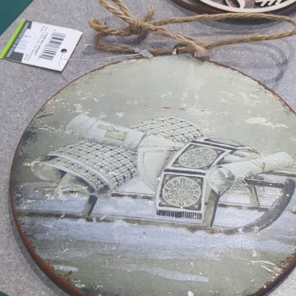 6 inch tin ornament with a sled
