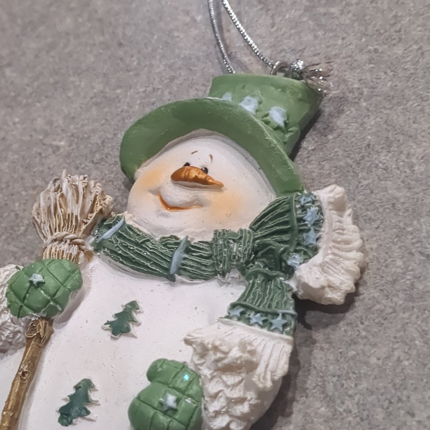 Polycrylic snowman ornament with a broom - green